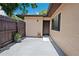 Inviting front entrance featuring a wooden fence, neutral stucco, and dark brown front door with a small, shaded patio at 8436 60Th N St # 304, Pinellas Park, FL 33781