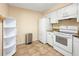 Functional kitchen features white cabinetry and appliances, complemented by ample storage and counter space at 8436 60Th N St # 304, Pinellas Park, FL 33781