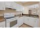 Efficient kitchen design with white appliances, granite countertops, and a pass-through to the adjacent dining area at 8436 60Th N St # 304, Pinellas Park, FL 33781