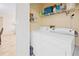 Laundry room with a washer and dryer set and a storage shelf, next to the doorway at 8436 60Th N St # 304, Pinellas Park, FL 33781