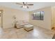 Well-lit living room boasts tile floors, a comfortable sofa, and a window for natural light and outdoor scenery at 8436 60Th N St # 304, Pinellas Park, FL 33781