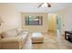 Bright living room features neutral tones, tile flooring, and a large window offering serene outdoor views at 8436 60Th N St # 304, Pinellas Park, FL 33781