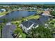 Aerial shot of the neighborhood with a lake surrounded by lush greenery at 8518 Tidal Bay Ln, Tampa, FL 33635