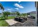 Backyard featuring an outdoor table, a daybed, and stunning lake views at 8518 Tidal Bay Ln, Tampa, FL 33635