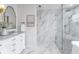 Modern bathroom with marble countertops, white cabinets and a large glass enclosed shower at 8518 Tidal Bay Ln, Tampa, FL 33635