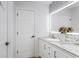 Bright bathroom boasts dual vanity, marble countertop, and decorative backsplash with accent lighting at 8518 Tidal Bay Ln, Tampa, FL 33635