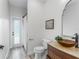 Stylish bathroom with modern vessel sink and unique mirror; bright and airy at 8518 Tidal Bay Ln, Tampa, FL 33635