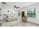 Bright bedroom with soft, neutral decor, modern ceiling fan, and natural light at 8518 Tidal Bay Ln, Tampa, FL 33635