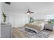 Comfortable bedroom features plush bedding, soft rug and a ceiling fan at 8518 Tidal Bay Ln, Tampa, FL 33635