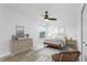 Comfortable bedroom with light wood-look floors, neutral decor, and lots of light at 8518 Tidal Bay Ln, Tampa, FL 33635