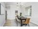 Bright dining room features modern chandelier and table with seating for six at 8518 Tidal Bay Ln, Tampa, FL 33635