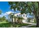 Charming two-story home with manicured lawn and lush tropical landscaping at 8518 Tidal Bay Ln, Tampa, FL 33635