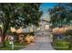 Charming two-story home featuring a well-manicured lawn and mature trees at 8518 Tidal Bay Ln, Tampa, FL 33635
