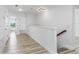 Spacious hallway featuring wood-look floors, neutral walls, and natural light at 8518 Tidal Bay Ln, Tampa, FL 33635