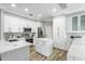 Bright kitchen featuring white cabinets, quartz countertops and stainless appliances at 8518 Tidal Bay Ln, Tampa, FL 33635