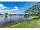 Backyard lake view with lush landscaping at 8518 Tidal Bay Ln, Tampa, FL 33635