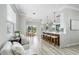 Open-concept living room with white furniture and hardwood floors at 8518 Tidal Bay Ln, Tampa, FL 33635