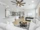 Bright living room featuring a ceiling fan and open access to the kitchen and dining area at 8518 Tidal Bay Ln, Tampa, FL 33635