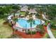 Resort-style pool area featuring a covered patio with tables and chairs with mature palm trees at 8518 Tidal Bay Ln, Tampa, FL 33635