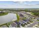 Aerial view of a residential community with a scenic lake and lush green landscapes, showcasing a peaceful neighborhood at 9577 Sandy Bluffs Cir, Parrish, FL 34219