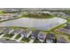 Aerial view showcasing homes located near a lake in a quiet neighborhood at 9577 Sandy Bluffs Cir, Parrish, FL 34219