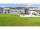 Well-maintained backyard featuring a patio area with outdoor furniture, ideal for relaxing and entertaining guests at 9577 Sandy Bluffs Cir, Parrish, FL 34219