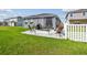 Private backyard features a screened lanai, patio, and manicured lawn at 9577 Sandy Bluffs Cir, Parrish, FL 34219