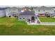 Aerial view of a backyard featuring a patio with seating and landscaped stone area at 9577 Sandy Bluffs Cir, Parrish, FL 34219