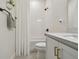 This bathroom features a modern vanity with brass fixtures, a shower with white subway tile and a white shower curtain at 9577 Sandy Bluffs Cir, Parrish, FL 34219