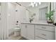 Bright bathroom featuring a modern vanity, quartz countertop, and tub with white subway tile at 9577 Sandy Bluffs Cir, Parrish, FL 34219