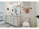 Bathroom with double sink vanity with white cabinets, modern fixtures and tile flooring at 9577 Sandy Bluffs Cir, Parrish, FL 34219