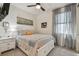 Comfortable bedroom with ceiling fan, soft lighting, and a serene sailboat art piece at 9577 Sandy Bluffs Cir, Parrish, FL 34219