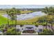 Sawgrass Lakes community entrance with lush landscaping and tranquil pond views at 9577 Sandy Bluffs Cir, Parrish, FL 34219