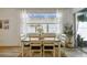 Dining room with natural light, view of the backyard and contemporary furnishings at 9577 Sandy Bluffs Cir, Parrish, FL 34219