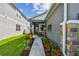 Inviting front porch with a stylish entrance is framed by colorful landscaping and stone accents at 9577 Sandy Bluffs Cir, Parrish, FL 34219
