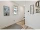 Bright hallway featuring wood-look floors, a heron painting, and modern decor at 9577 Sandy Bluffs Cir, Parrish, FL 34219