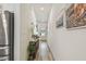 Bright hallway with wood-look floors, console table, decorations, and view of the front door at 9577 Sandy Bluffs Cir, Parrish, FL 34219