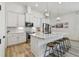 Beautiful modern kitchen with stainless steel appliances, a kitchen island with stool seating, and sleek finishes at 9577 Sandy Bluffs Cir, Parrish, FL 34219