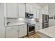 Well-appointed kitchen with stainless steel appliances, white cabinets and beautiful countertops at 9577 Sandy Bluffs Cir, Parrish, FL 34219