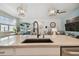 Large kitchen island featuring a sink and faucet and stainless dishwasher in an open-concept living space at 9577 Sandy Bluffs Cir, Parrish, FL 34219
