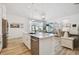 Open-concept kitchen with a center island, stainless steel dishwasher and sink, and modern finishes at 9577 Sandy Bluffs Cir, Parrish, FL 34219