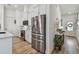 Well-equipped kitchen with modern appliances, white cabinetry, and views into the foyer and front door at 9577 Sandy Bluffs Cir, Parrish, FL 34219