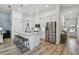 Contemporary kitchen with white cabinets, stainless steel appliances, and a center island with stool seating at 9577 Sandy Bluffs Cir, Parrish, FL 34219