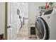 Spacious laundry area leads into the kitchen, equipped with modern appliances and ample storage, blending practicality and style at 9577 Sandy Bluffs Cir, Parrish, FL 34219