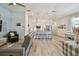 Open-concept living room with eat-in kitchen, island with barstool seating, and stainless steel appliances at 9577 Sandy Bluffs Cir, Parrish, FL 34219
