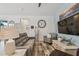 Cozy living room featuring a comfortable sofa, patterned chair, area rug, and decorative furnishings at 9577 Sandy Bluffs Cir, Parrish, FL 34219