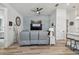 Spacious living room with wood-look floors, stylish decor, ceiling fan, and natural light at 9577 Sandy Bluffs Cir, Parrish, FL 34219