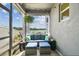 Inviting screened-in patio offering serene lake views, cozy seating, and charming decor for outdoor enjoyment at 9577 Sandy Bluffs Cir, Parrish, FL 34219