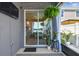 The screened patio features a view of the dining room with sliding doors and a small table, as well as outdoor plant decor at 9577 Sandy Bluffs Cir, Parrish, FL 34219