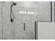 Walk-in shower with glass door, black hardware and marble-look tile surround at 9577 Sandy Bluffs Cir, Parrish, FL 34219